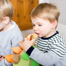 Load image into Gallery viewer, Young child kissing cuddly stegosaurus toy