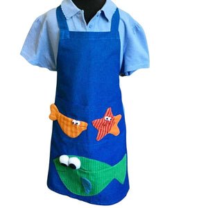 Child’s apron with green fish pattern on blue background