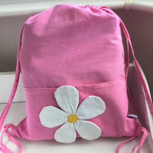 Pink fabric gym bag with white daisy on pocket
