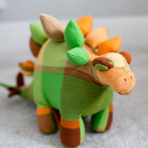 Large brightly coloured stegosaurus cuddly toy